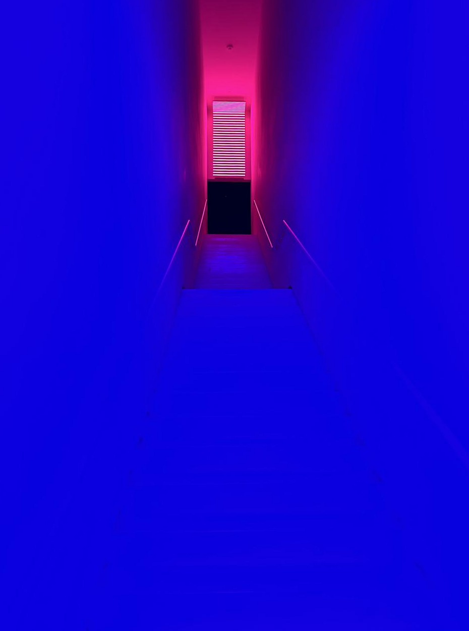 Viewpoint — a stairwell in deep blue light, a pink glow at the top